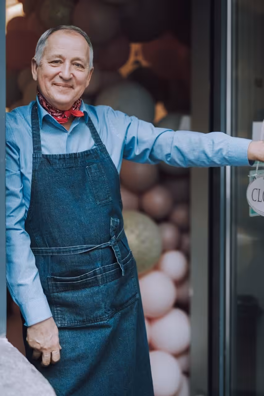 Small business owner standing at a shop entrance