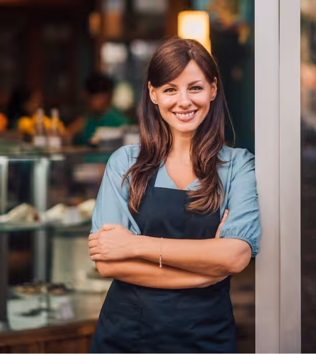 Small business owner standing at a shop entrance