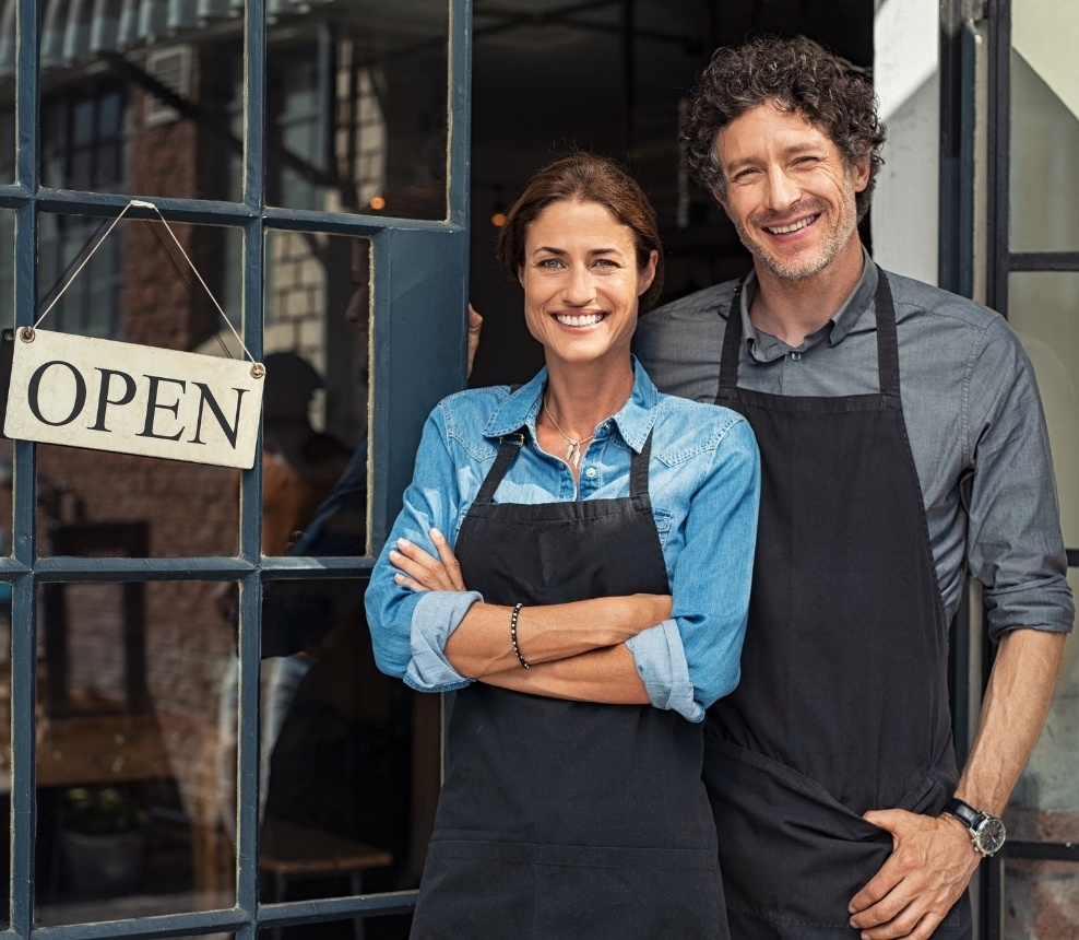 Small business owner standing at a storefront entrance